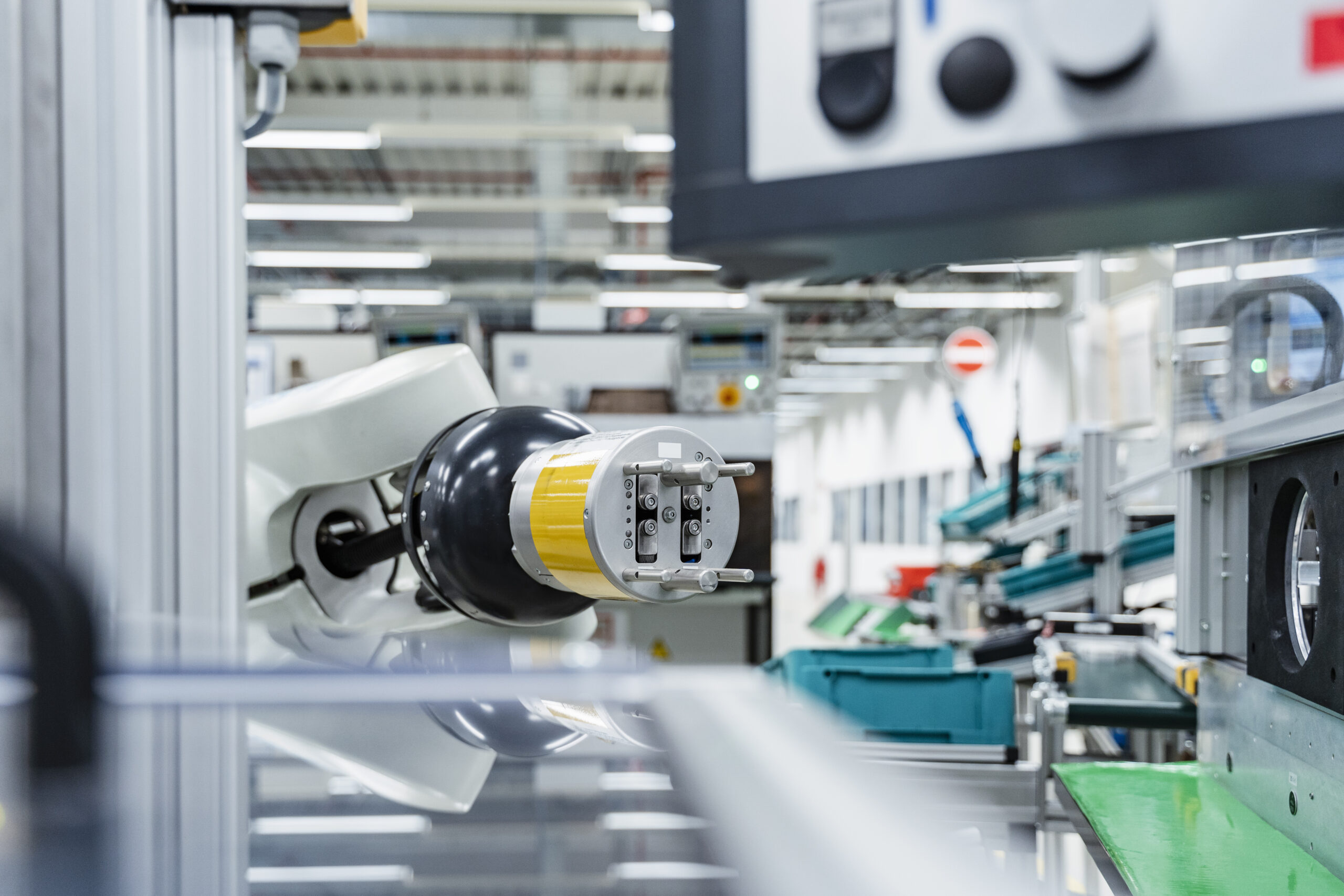 Arm of assembly robot functioning inside modern factory, Stuttgart, Germany