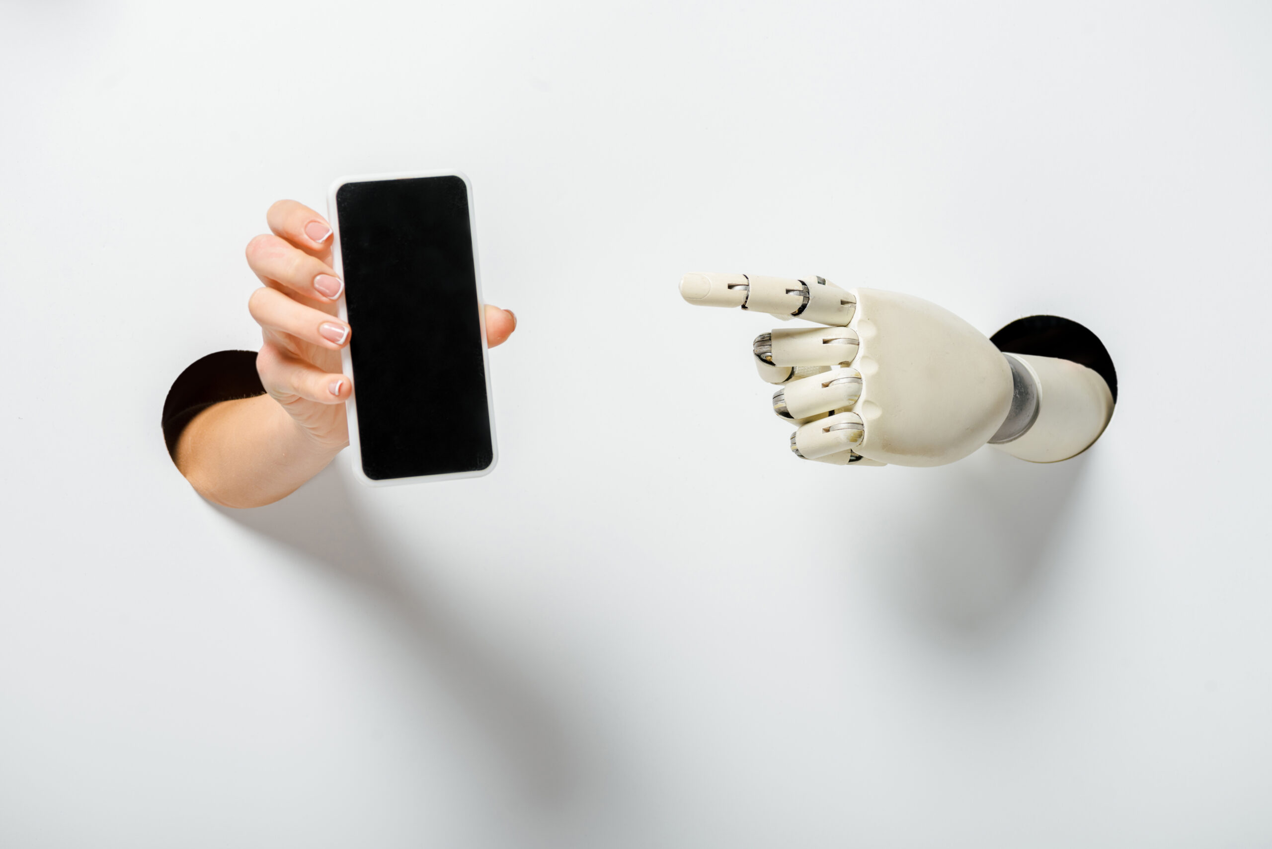 cropped image of woman holding smartphone with blank screen and robot pointing on it through holes
