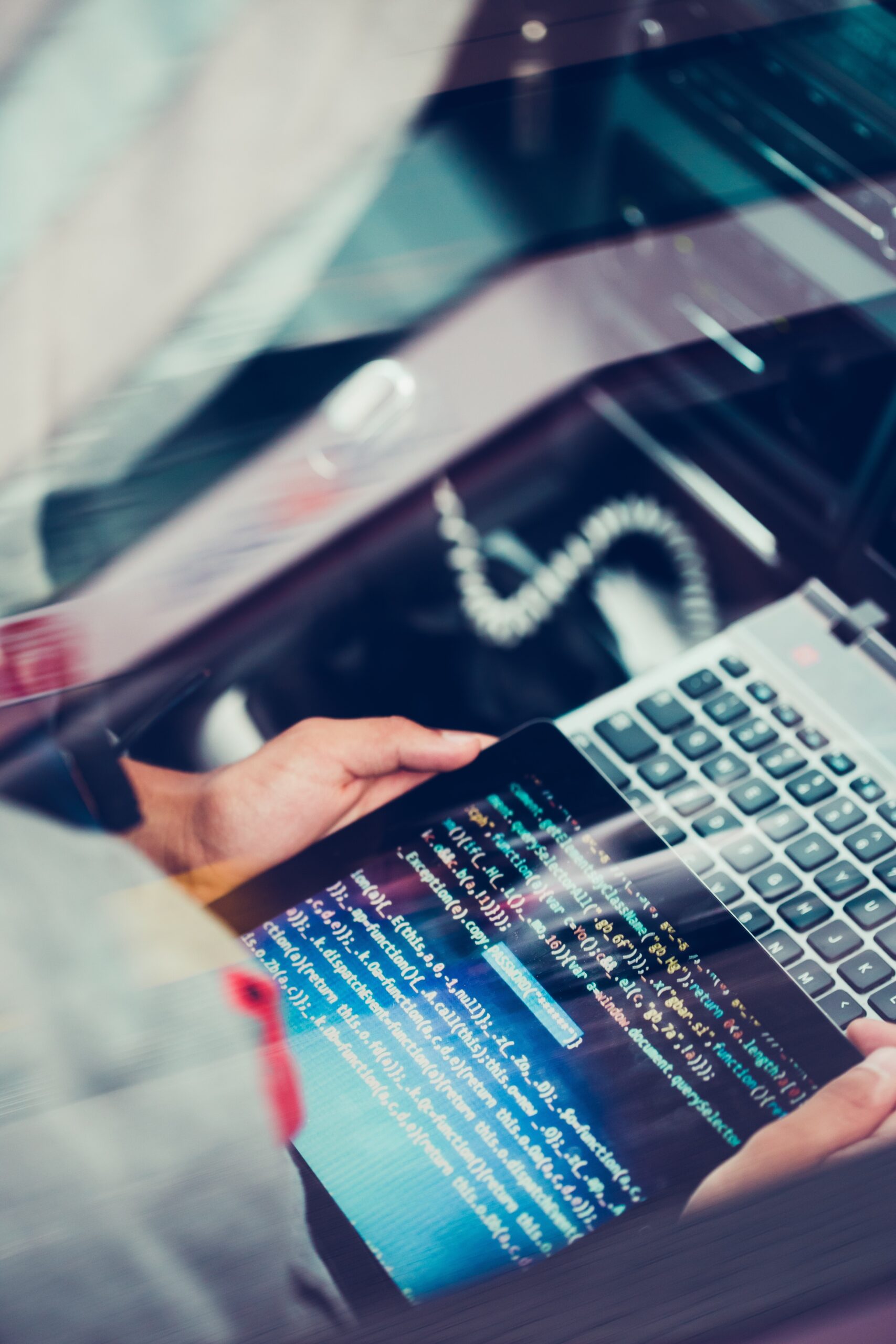 Hacker using computer, smartphone and coding to steal password and private data