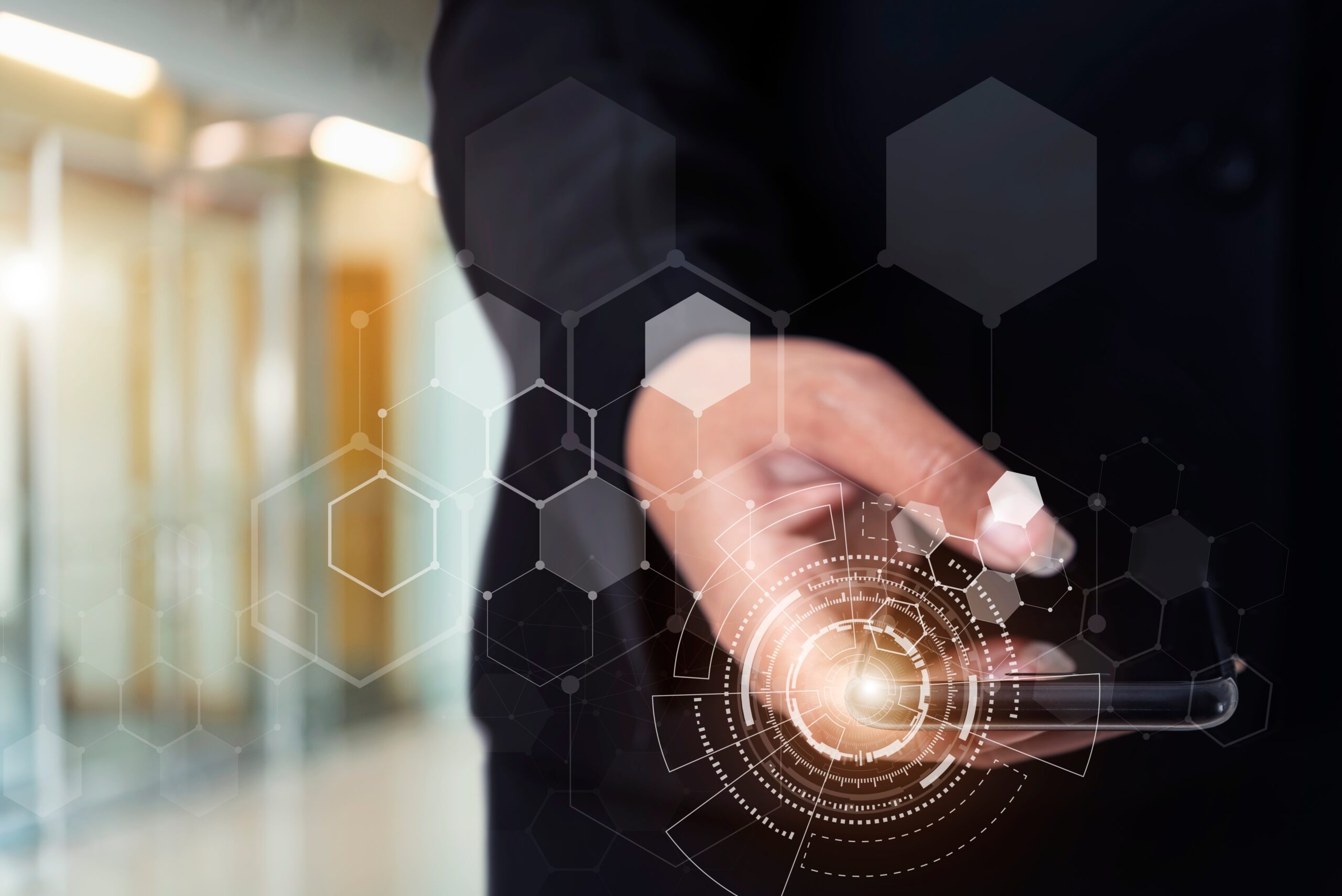 Businessman holding smartphone with technology icons with blurre